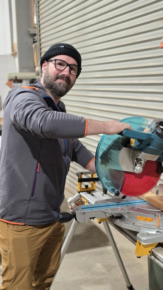 Rob Moss, a member of the Bright United Men's Shed, at the mitre saw