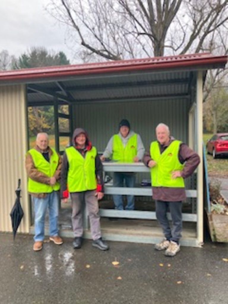 Four BUMS volunteers in hi-vis at the footy ground gate